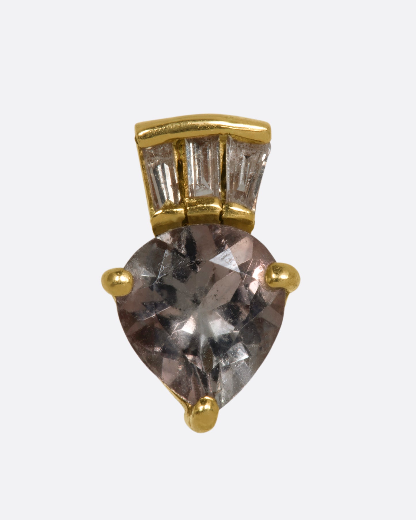 A yellow gold stud earring with a light yellow tourmaline and a baguette diamond crown. Shown from the front.