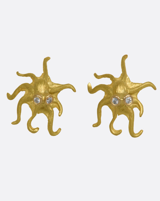 Yellow gold octopus earrings with diamond eyes. View from the front.