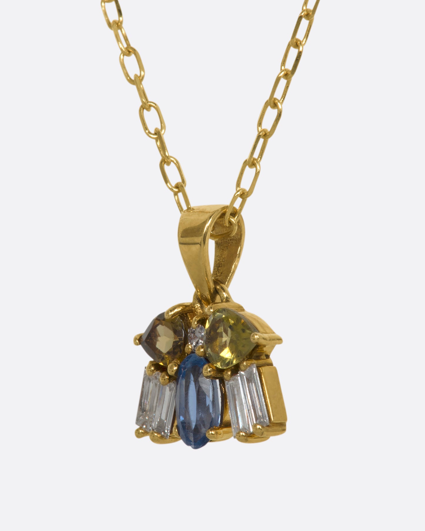 A yellow gold necklace with a winged bug pendant made of tourmalines, kyanite and diamonds. View from the side.