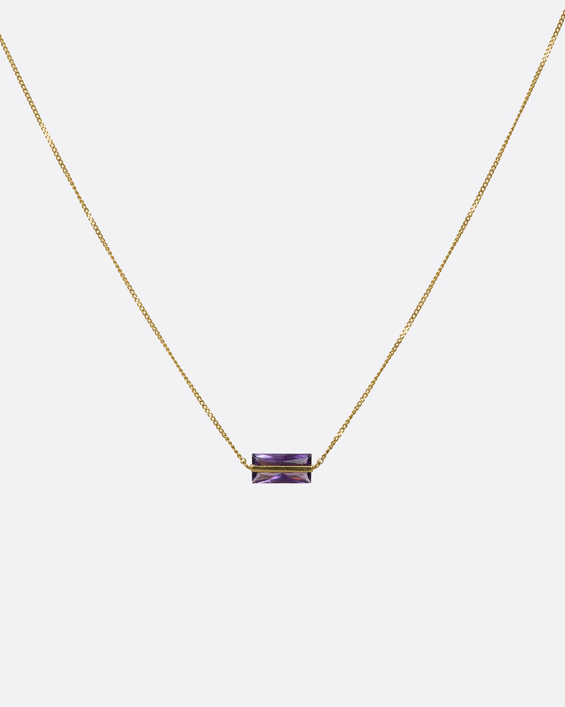 A rectangular amethyst threaded along a fine 10k gold chain