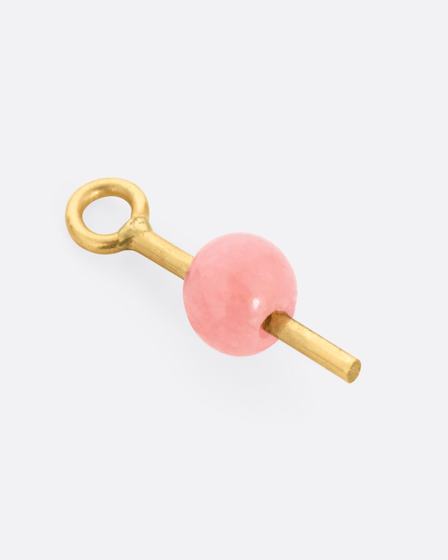 A yellow gold earring dangle with a pink rhodochrosite bead, shown from the side.