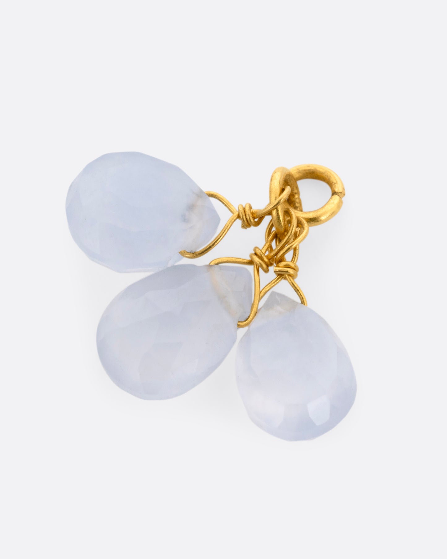  A yellow gold earring dangle with a chalcedony briolette trio, shown from the side.