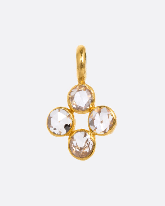 A yellow gold cross shaped charm with four diamonds. Shown from the front.