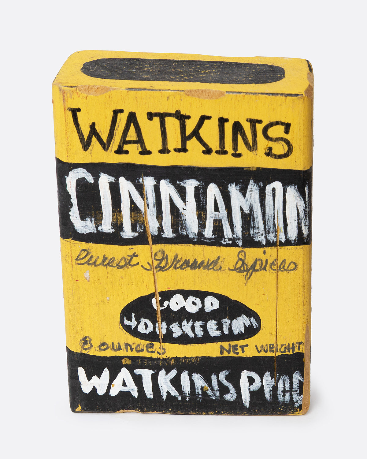 A yellow and black hand painted wooden box with the text 'WATKIN'S CINNAMON', shown from the front.