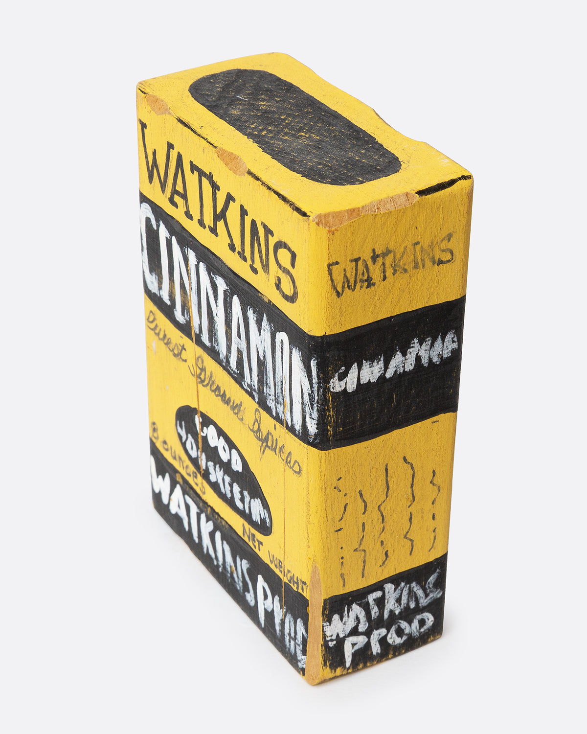 A yellow and black hand painted wooden box with the text 'WATKIN'S CINNAMON', shown from the side.