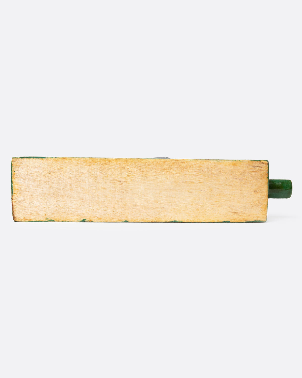 A wooden folk art toy with a yellow and blue woodpecker on a green base shown from the bottom.