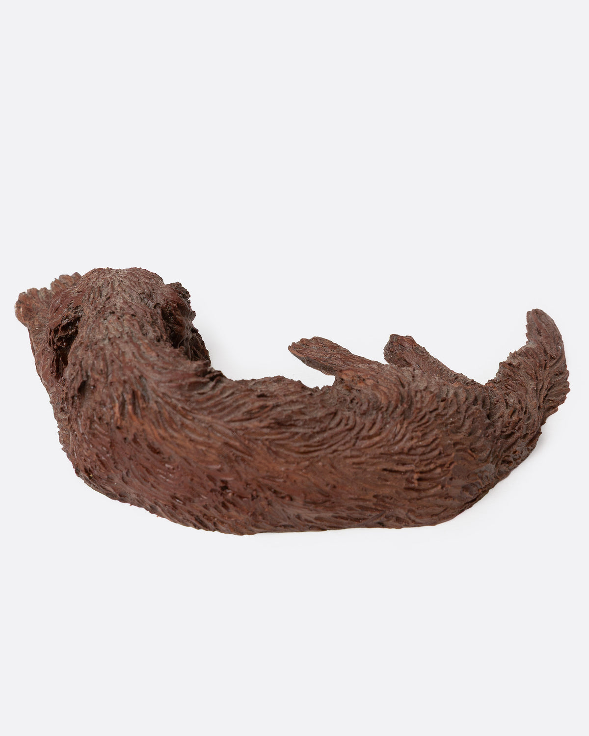 A brown resin dog figurine shown from the top.