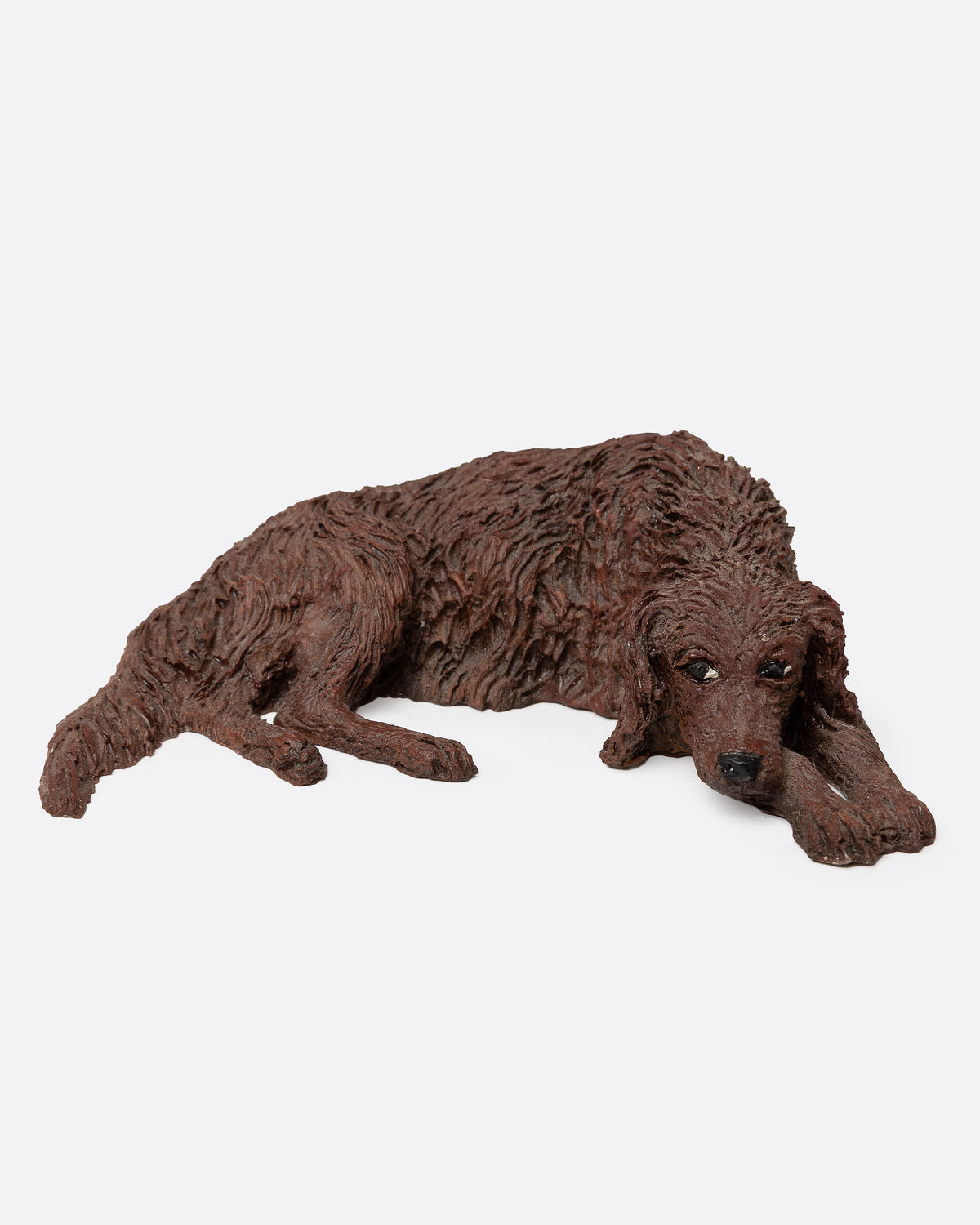 A brown resin dog figurine shown from the front.