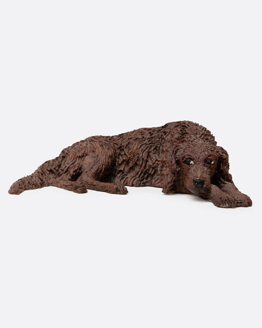 A brown resin dog figurine shown from the front.
