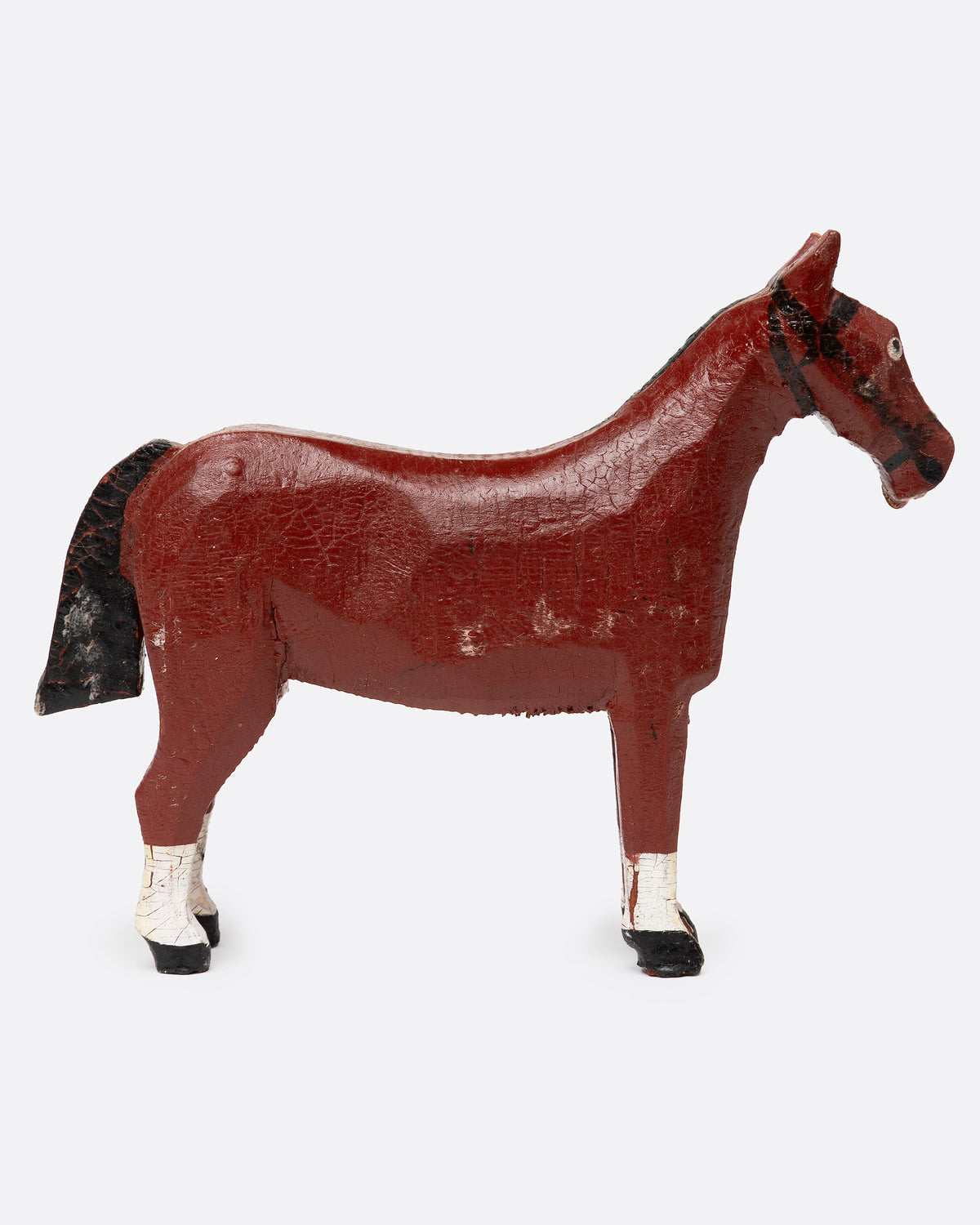 A hand painted and carved wooden bay horse, shown from the side.