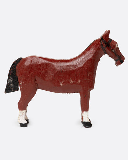 A hand painted and carved wooden bay horse, shown from the side.