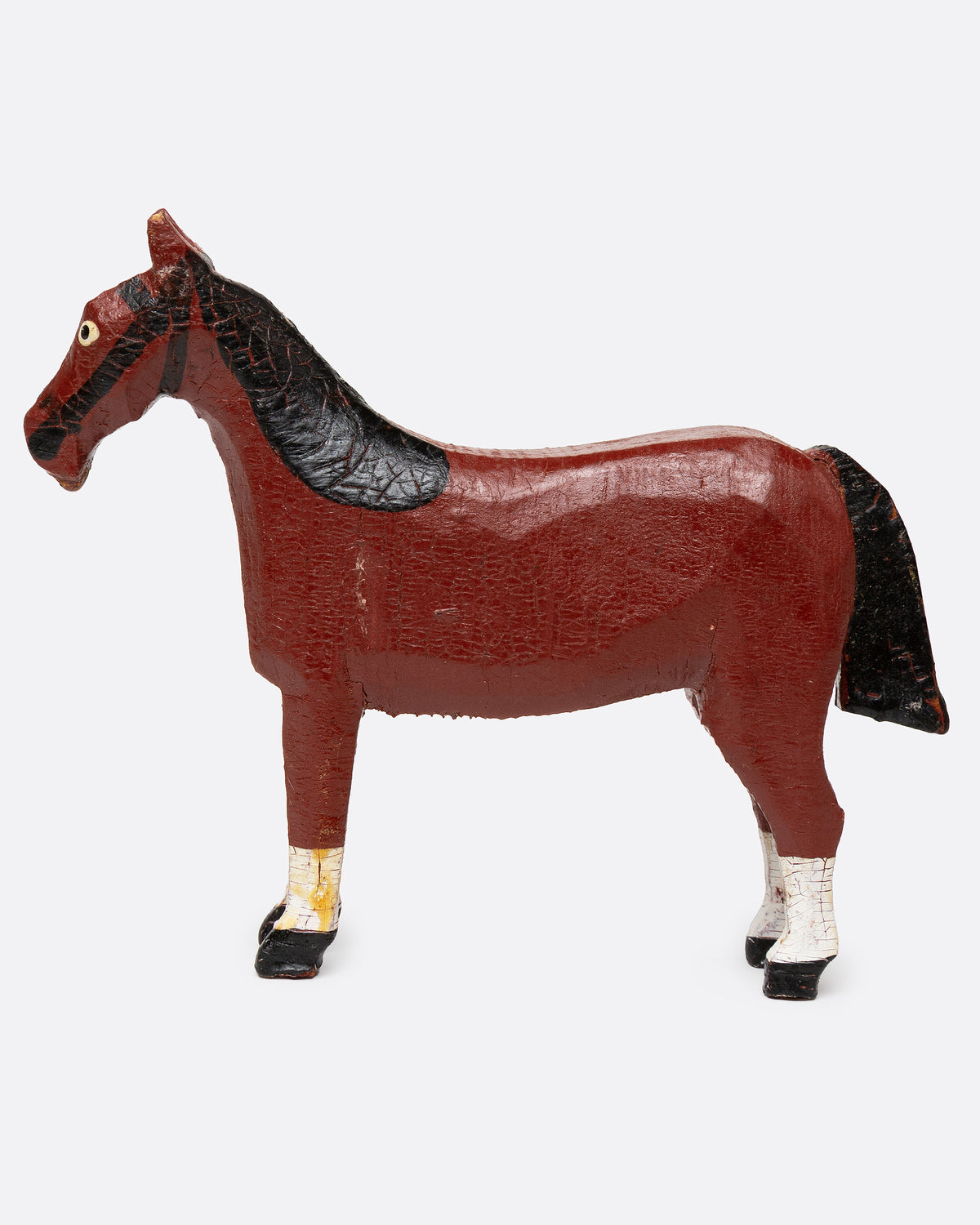 A hand painted and carved wooden bay horse, shown from the side.