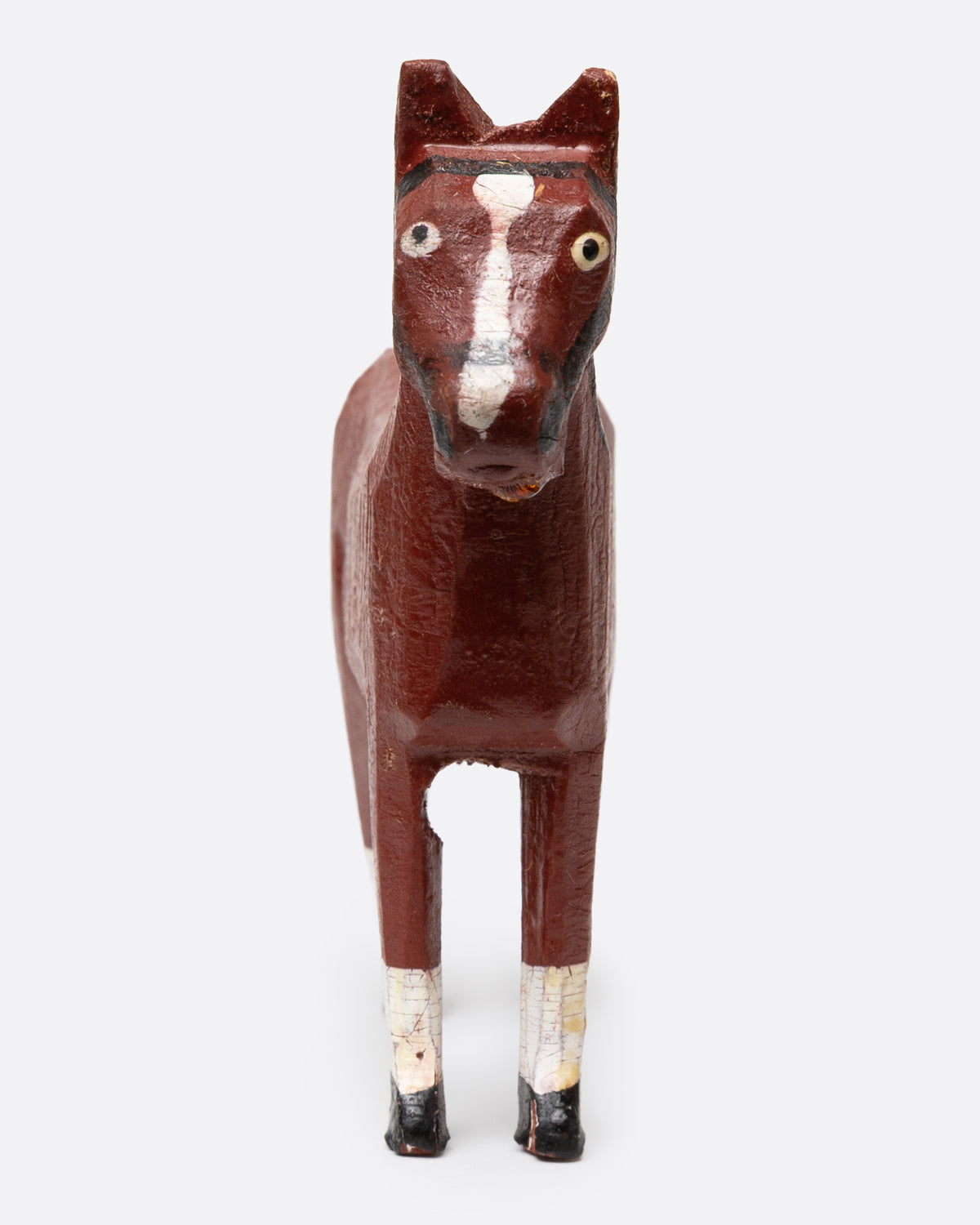 A hand painted and carved wooden bay horse, shown from the front.