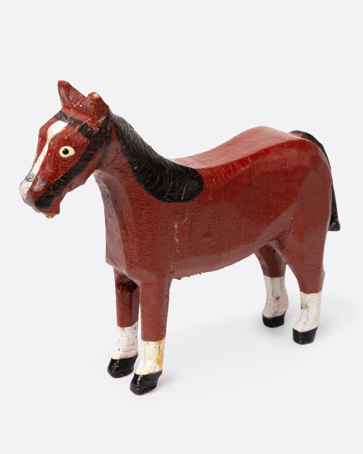 A hand painted and carved wooden bay horse, shown from the side.