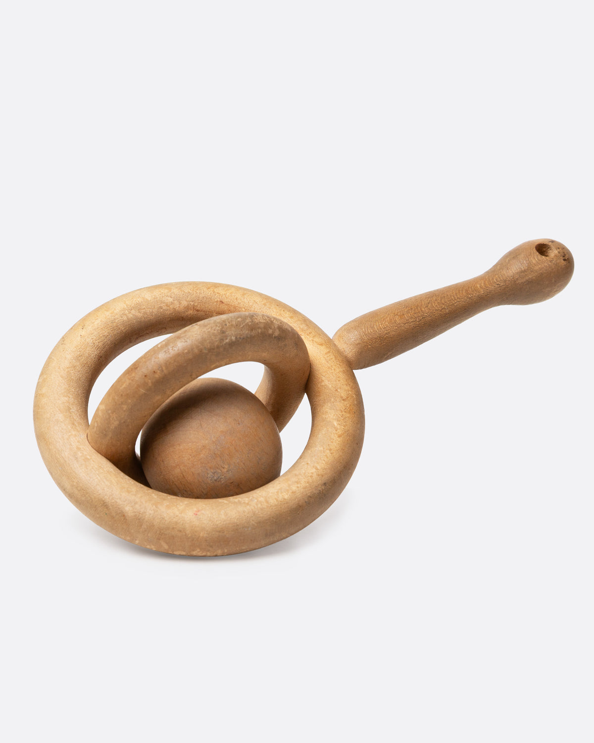 A hand carved baby rattle whimsy, shown from the side.
