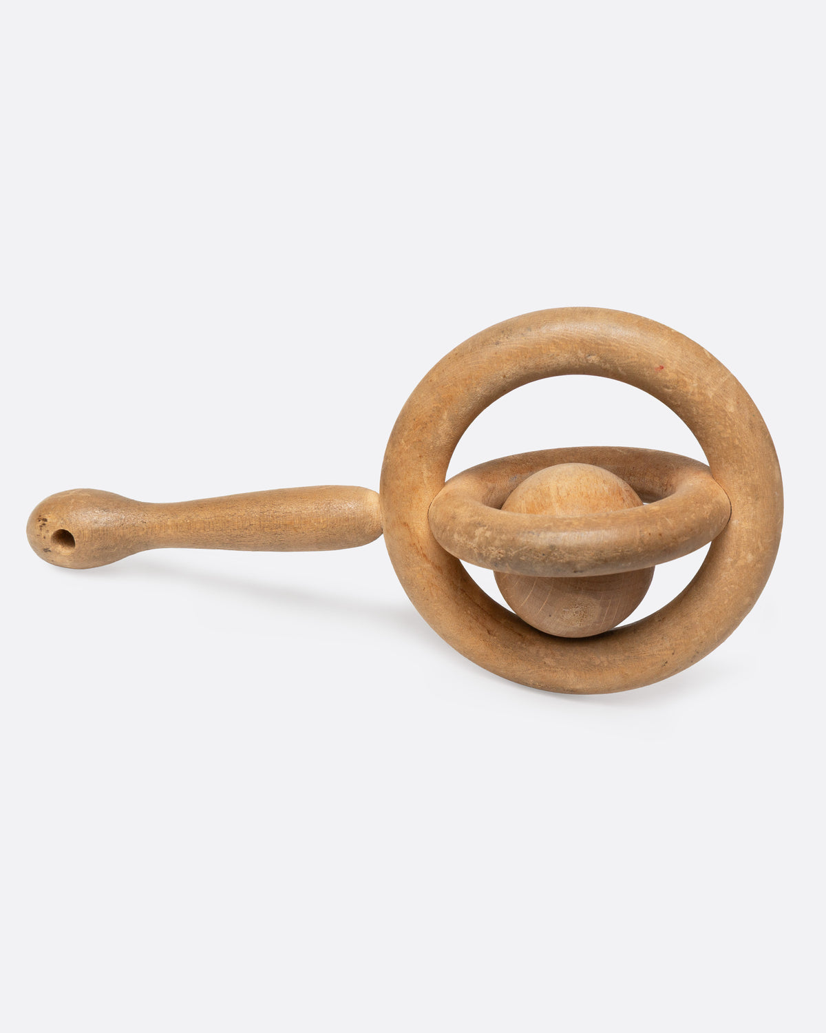 A hand carved baby rattle whimsy, shown from the side.