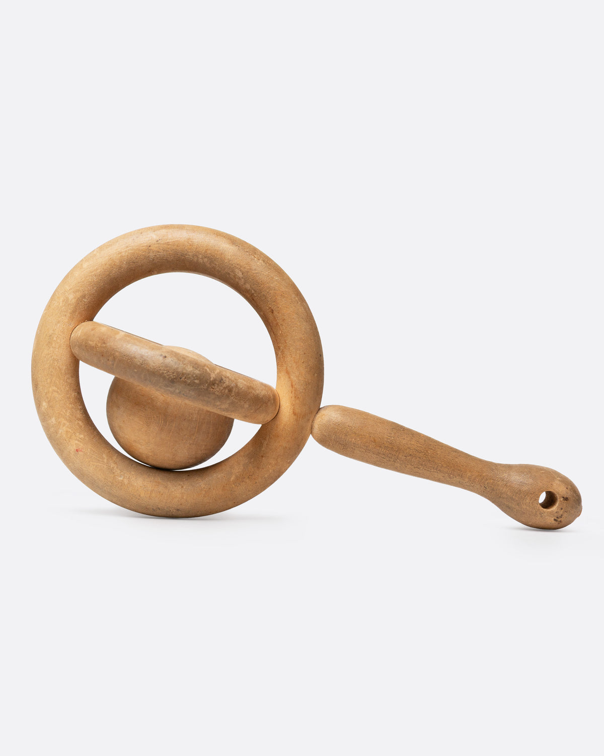 A hand carved baby rattle whimsy, shown from the side.