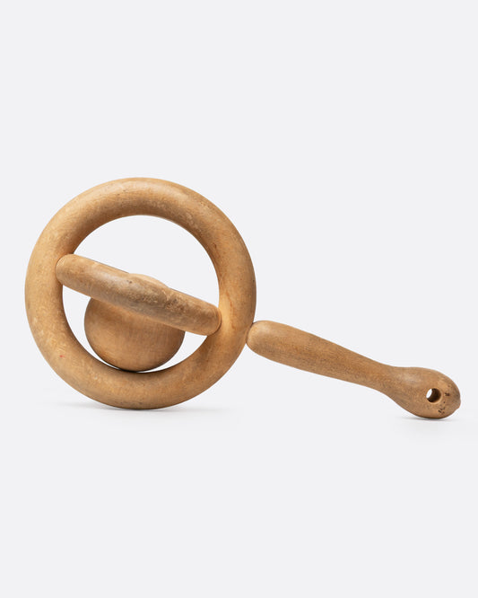 A hand carved baby rattle whimsy, shown from the side.