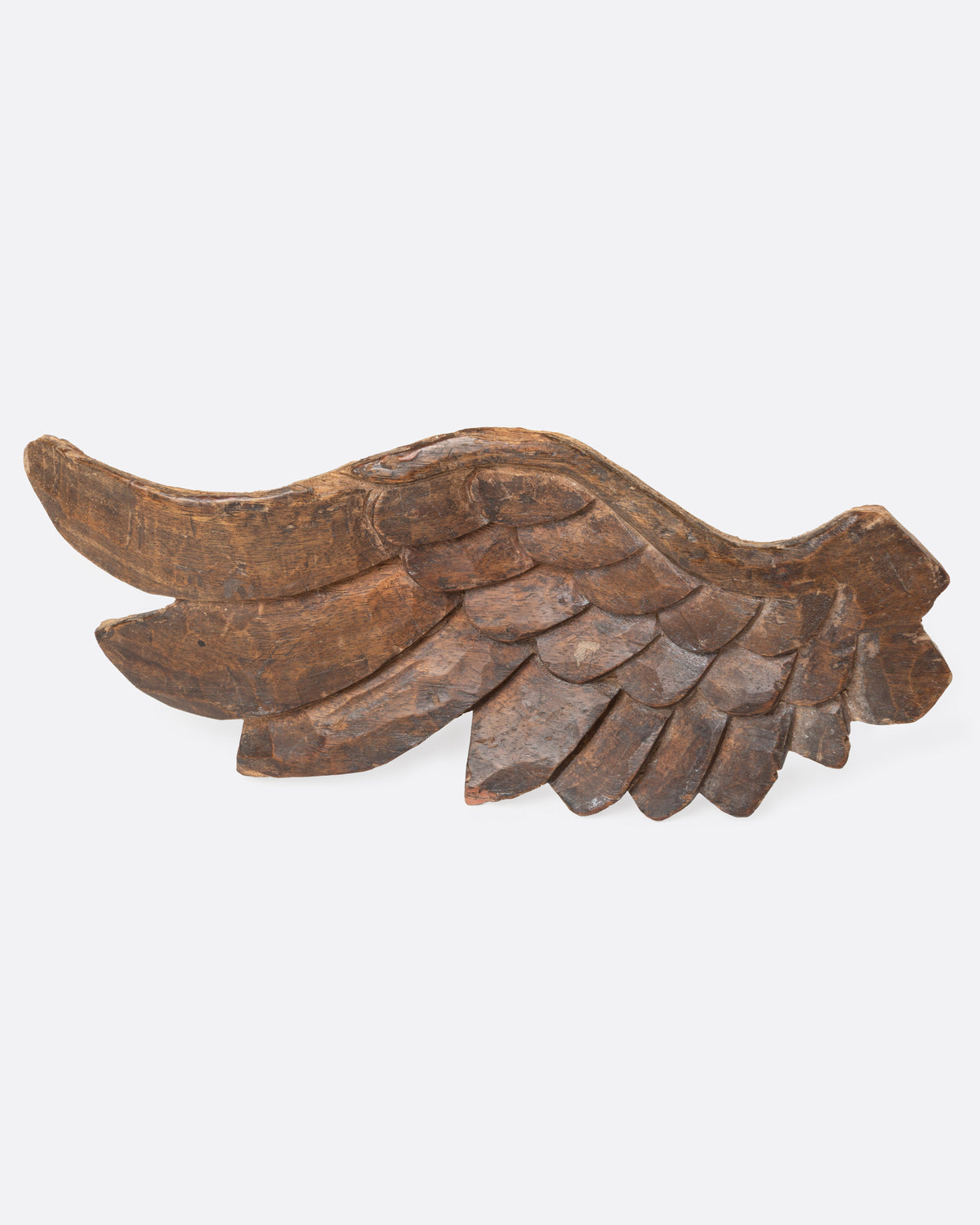 A wooden hand carved wing, shown from the front.
