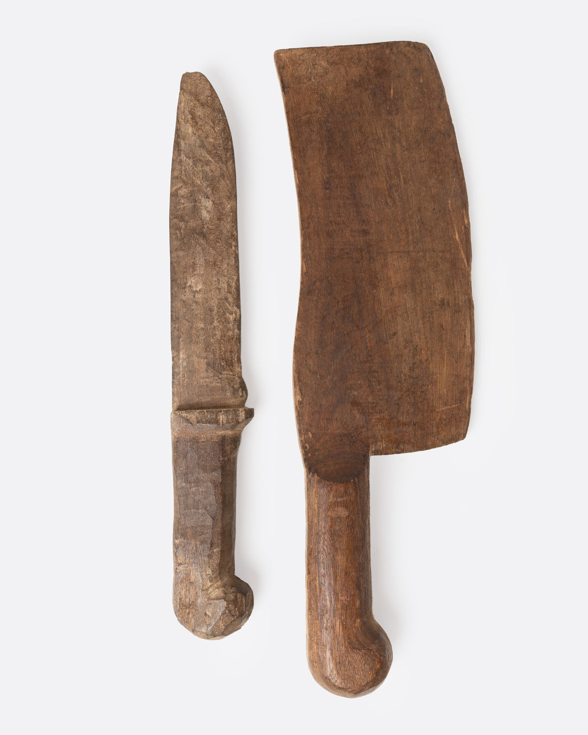 A hand carved wooden knife and cleaver set, shown from the side.