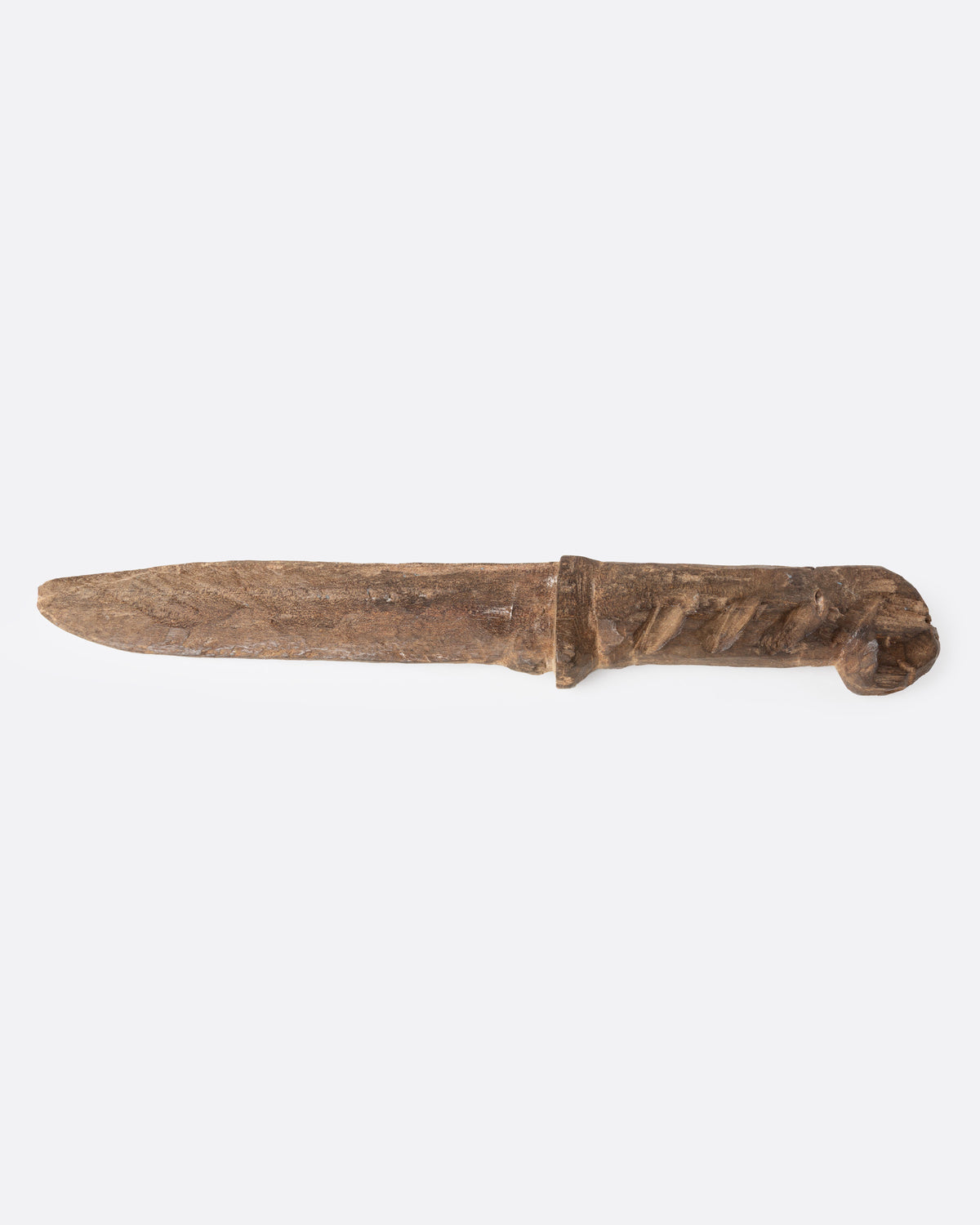 A hand carved wooden knife, shown from the side.