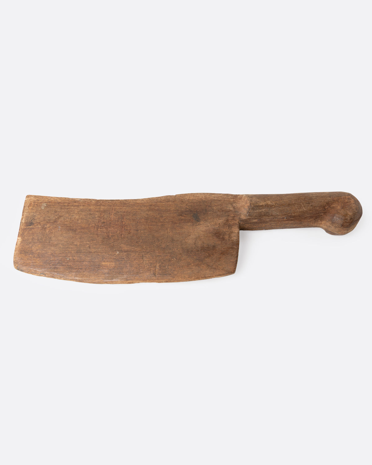 A hand carved wooden cleaver, shown from the side.