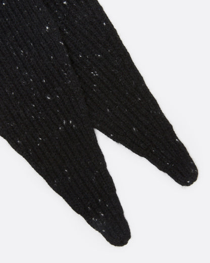A close up off a black ribbed knit scarf with tiny flecks.