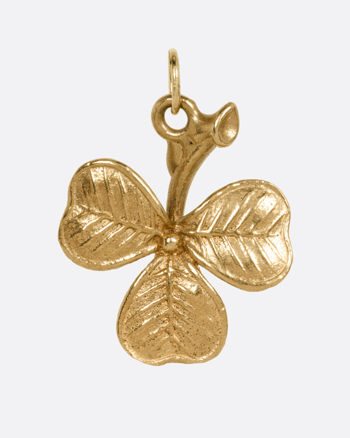 A yellow gold shamrock charm, shown from the front.