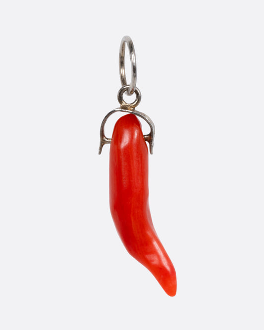 A sterling silver charm with a coral Italian horn, shown from the front.
