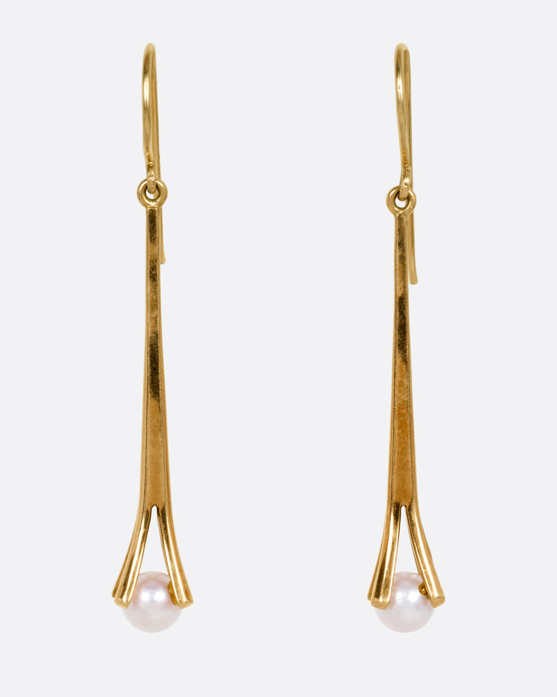 A pair of yellow gold drop earrings with a split vertical bar, and a single white pearl hanging from the bottom, shown from the front.