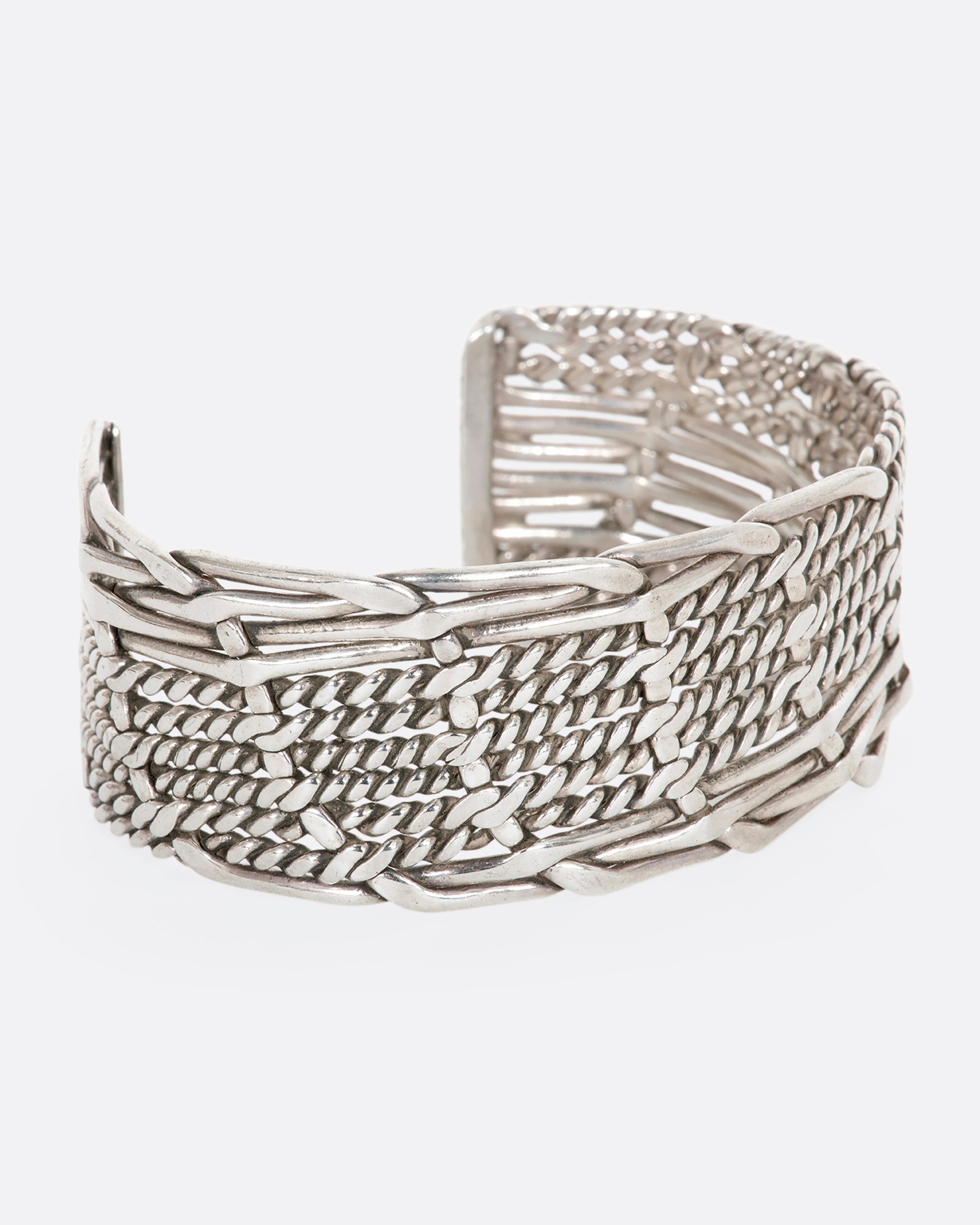 Sterling silver woven and twisted cuff. View from the side.