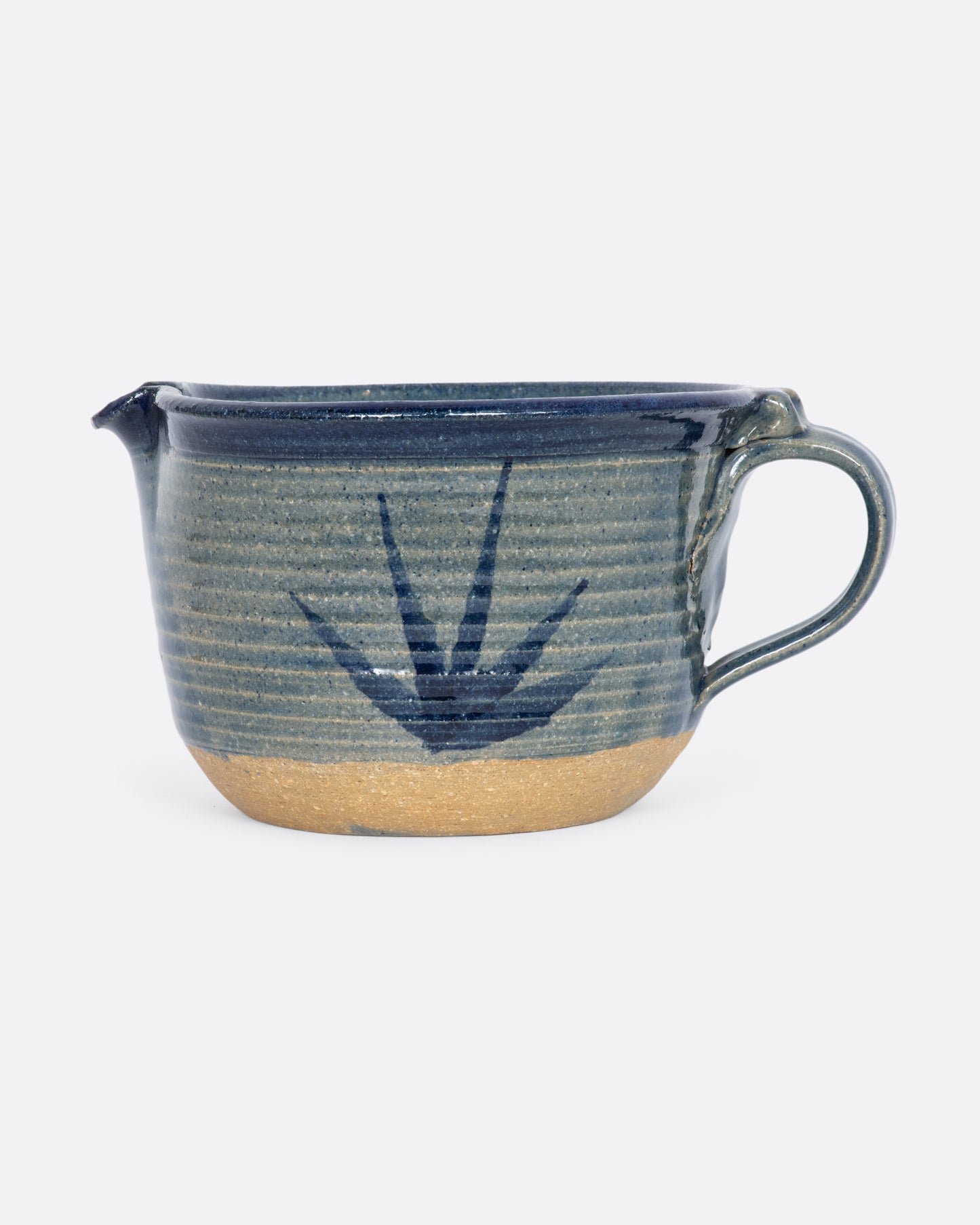 Blue ceramic batter bowl with an aloe plant.