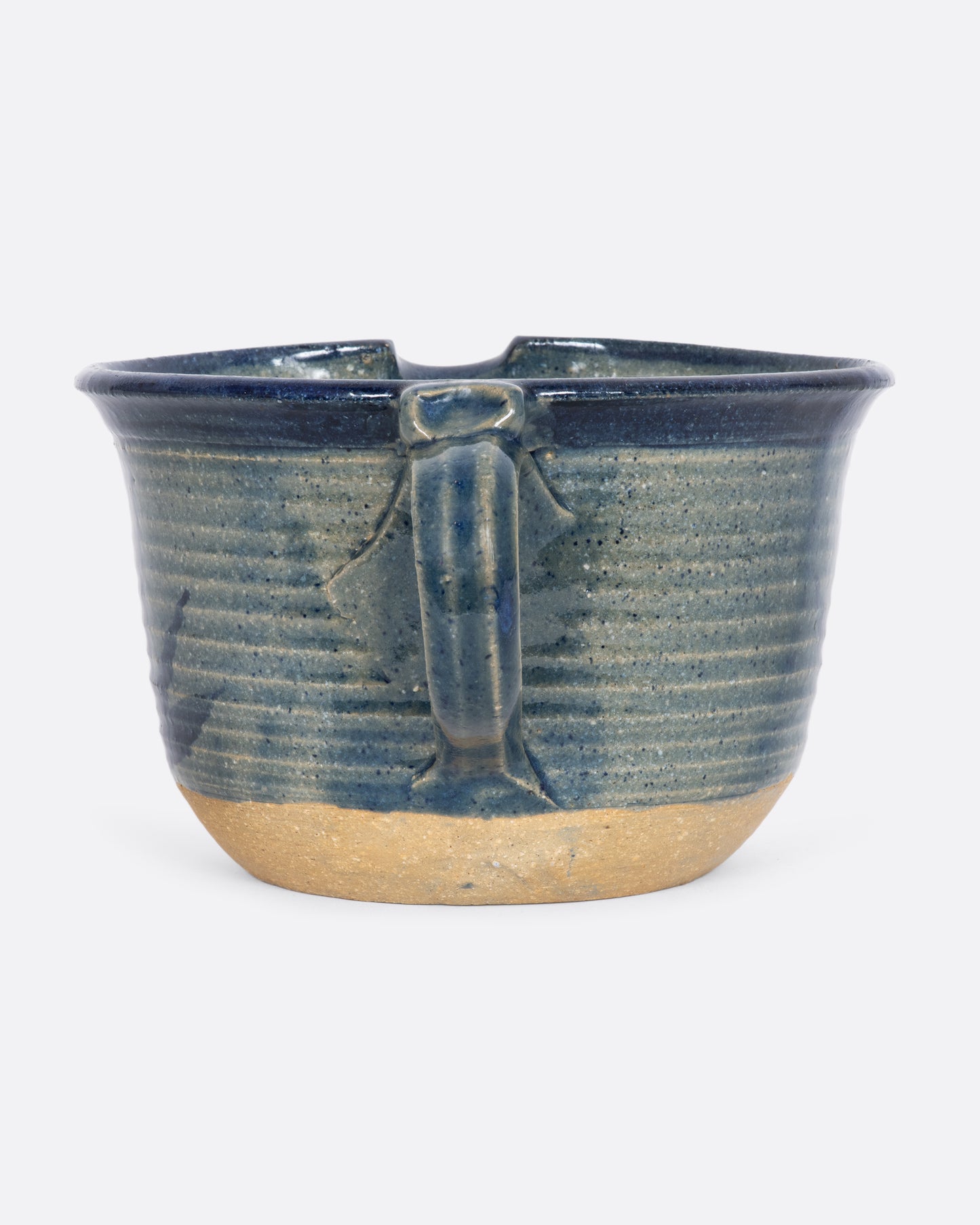 Blue ceramic batter bowl with an aloe plant. View of the handle.