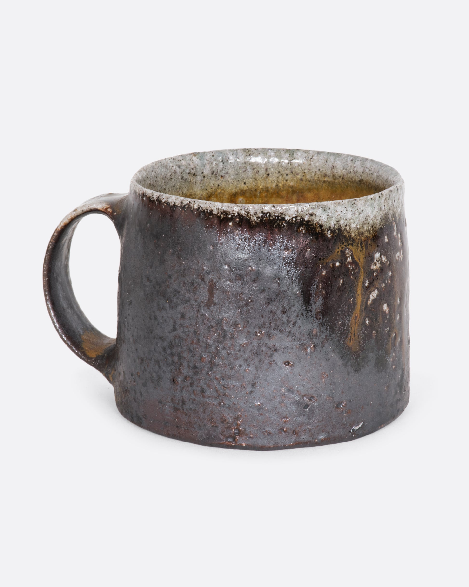 A hand thrown brown ceramic mug. View from the alternate side.