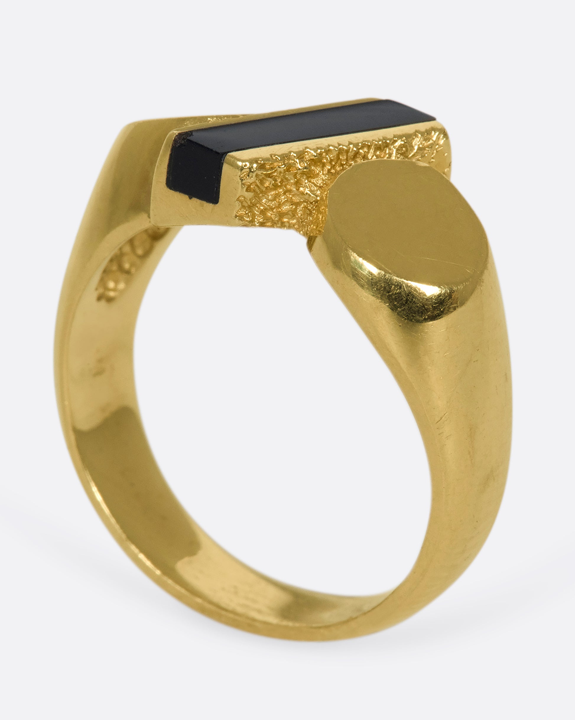 A vintage 14k gold puffy, rounded band with flat ends and a slice of onyx popping through the center