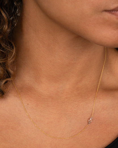 Todd Pownell necklace in 18k yellow gold worn, a marquise diamond set sideways along the chain on small platinum jump rings