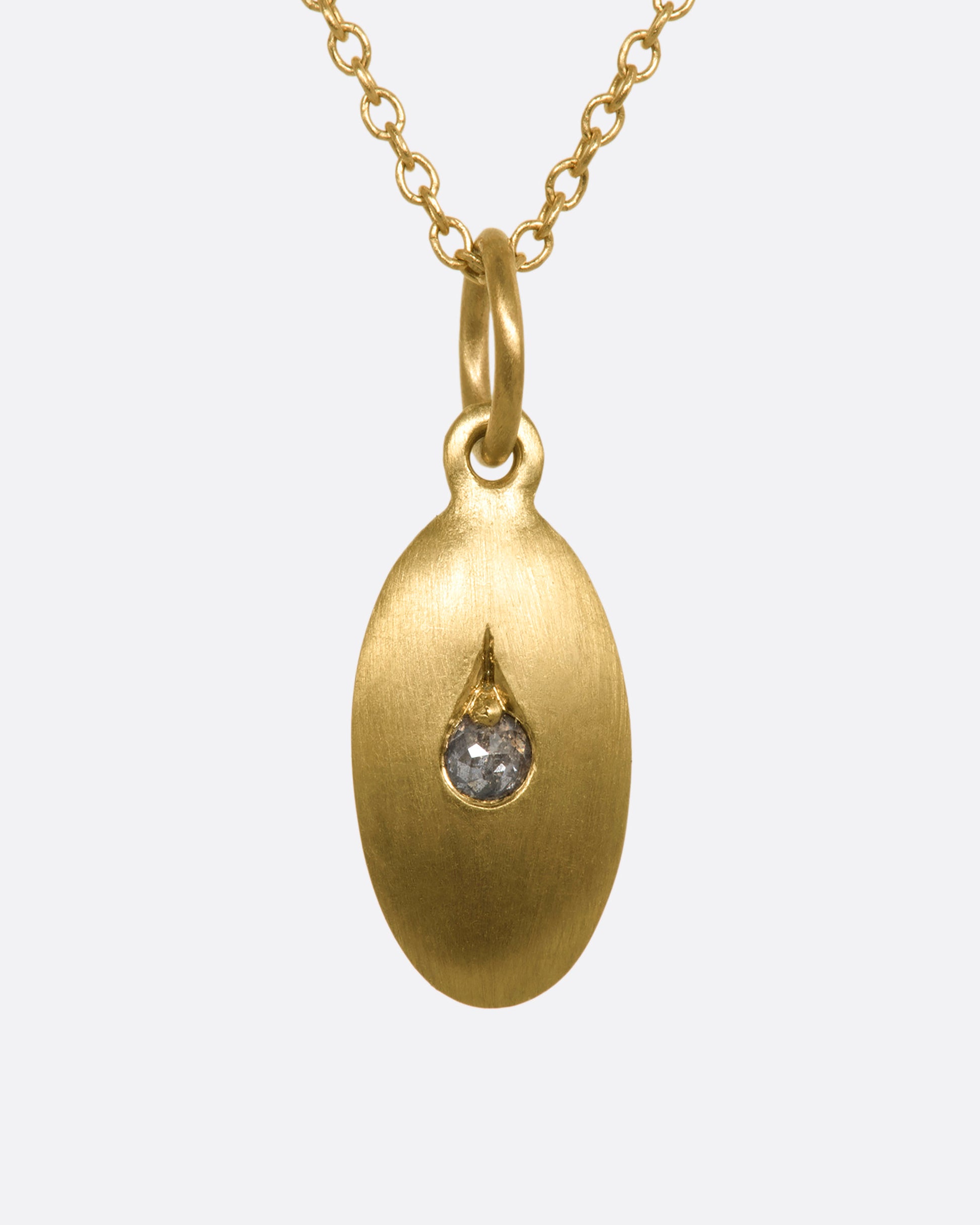 A yellow gold oval pendant with a diamond at the center. View from the front.