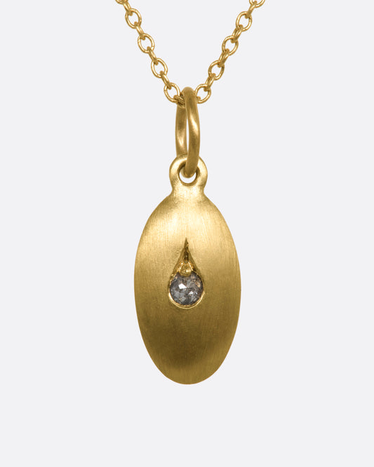 A yellow gold oval pendant with a diamond at the center. View from the front.