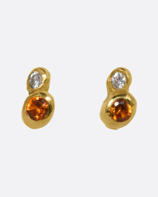 A pair of yellow gold bubble studs with orange sapphires and diamonds. Shown from the front.