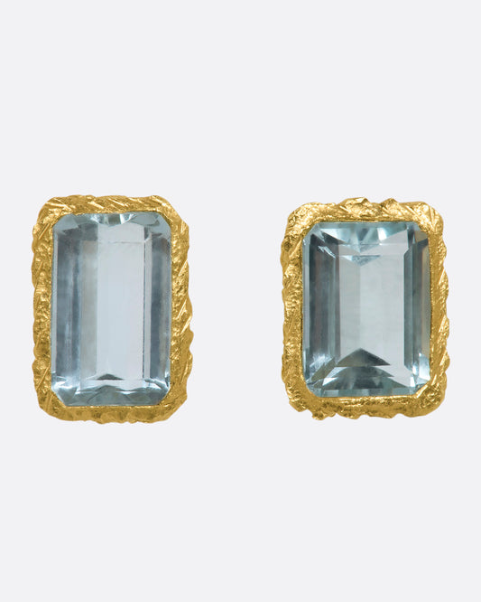 A yellow gold stud earrings with rectangular aquamarines. Shown from the front.