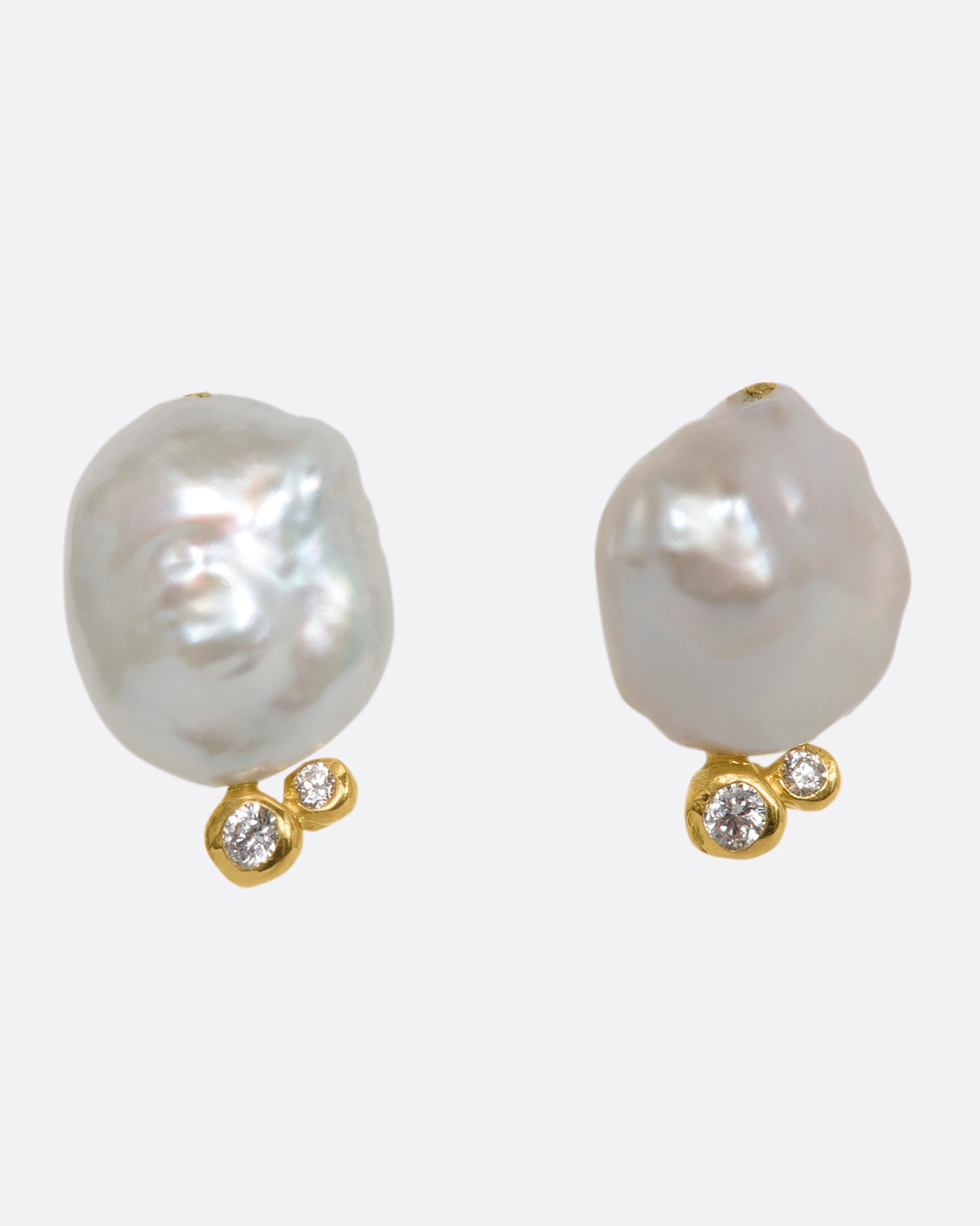 A pair of yellow gold studs with Keshi pearls and white diamonds. Shown from the front.