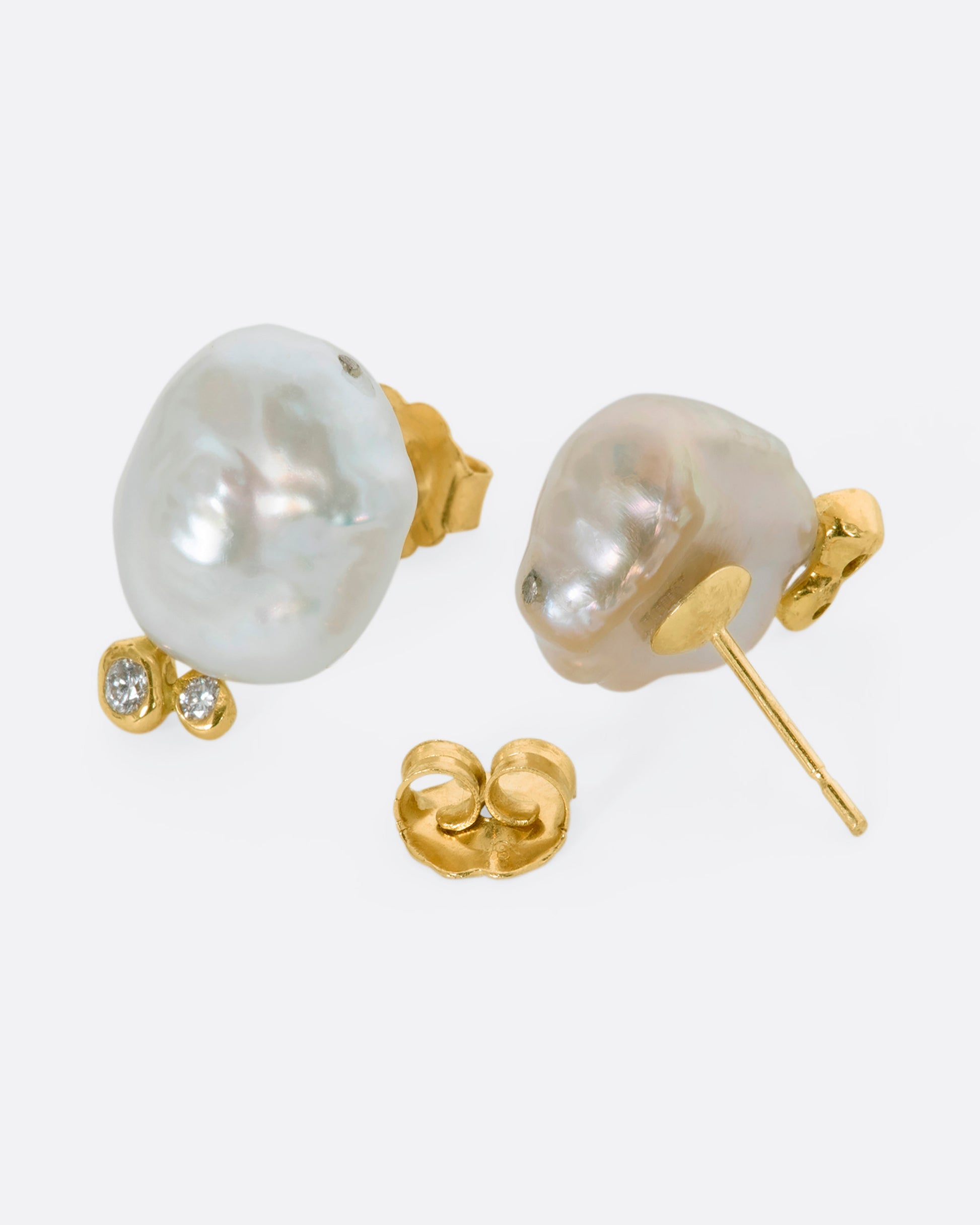 A pair of yellow gold studs with Keshi pearls and white diamonds. Shown from the back.