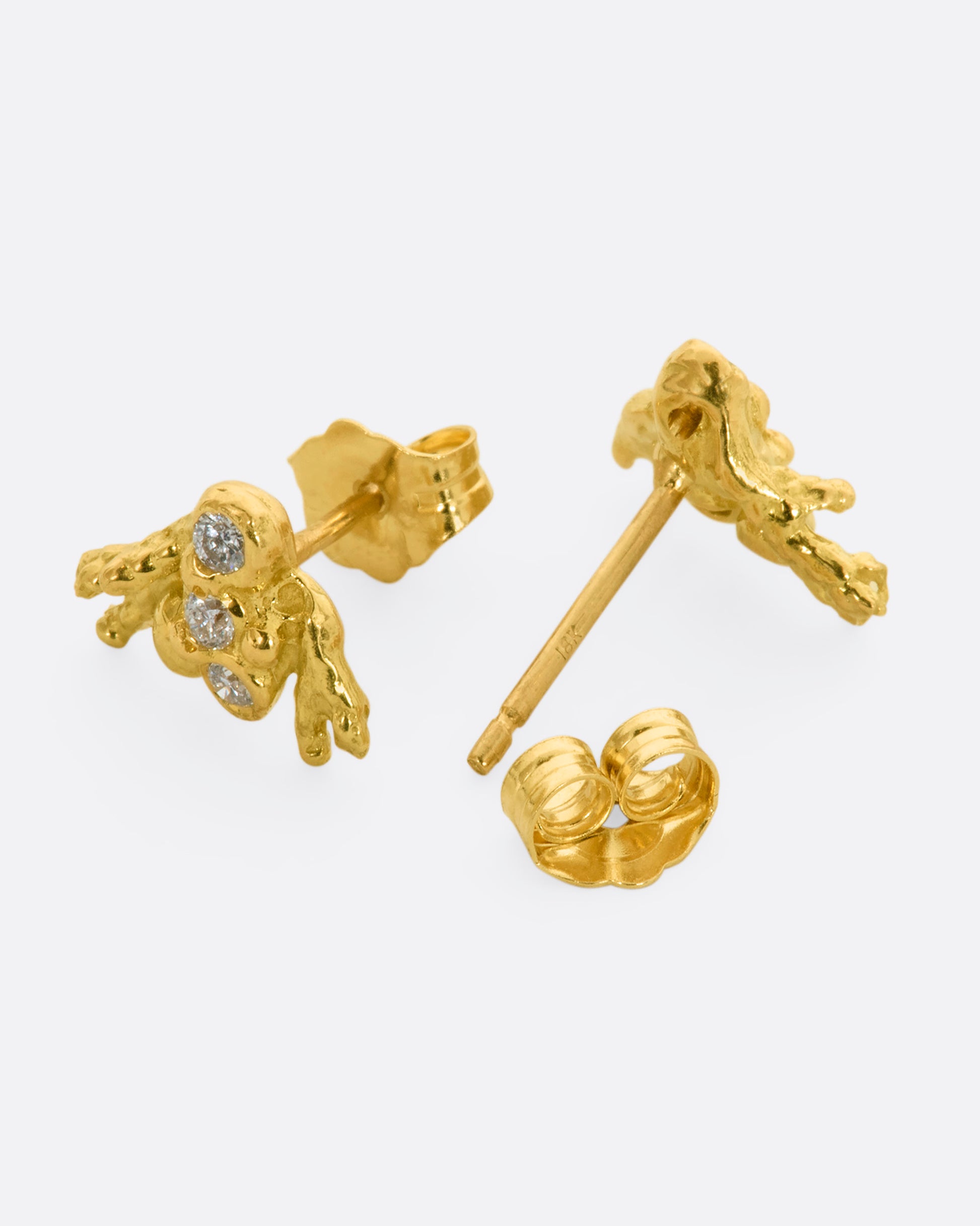 A pair of yellow gold studs abstractly shaped like a bee with diamonds. Shown from the front and back.