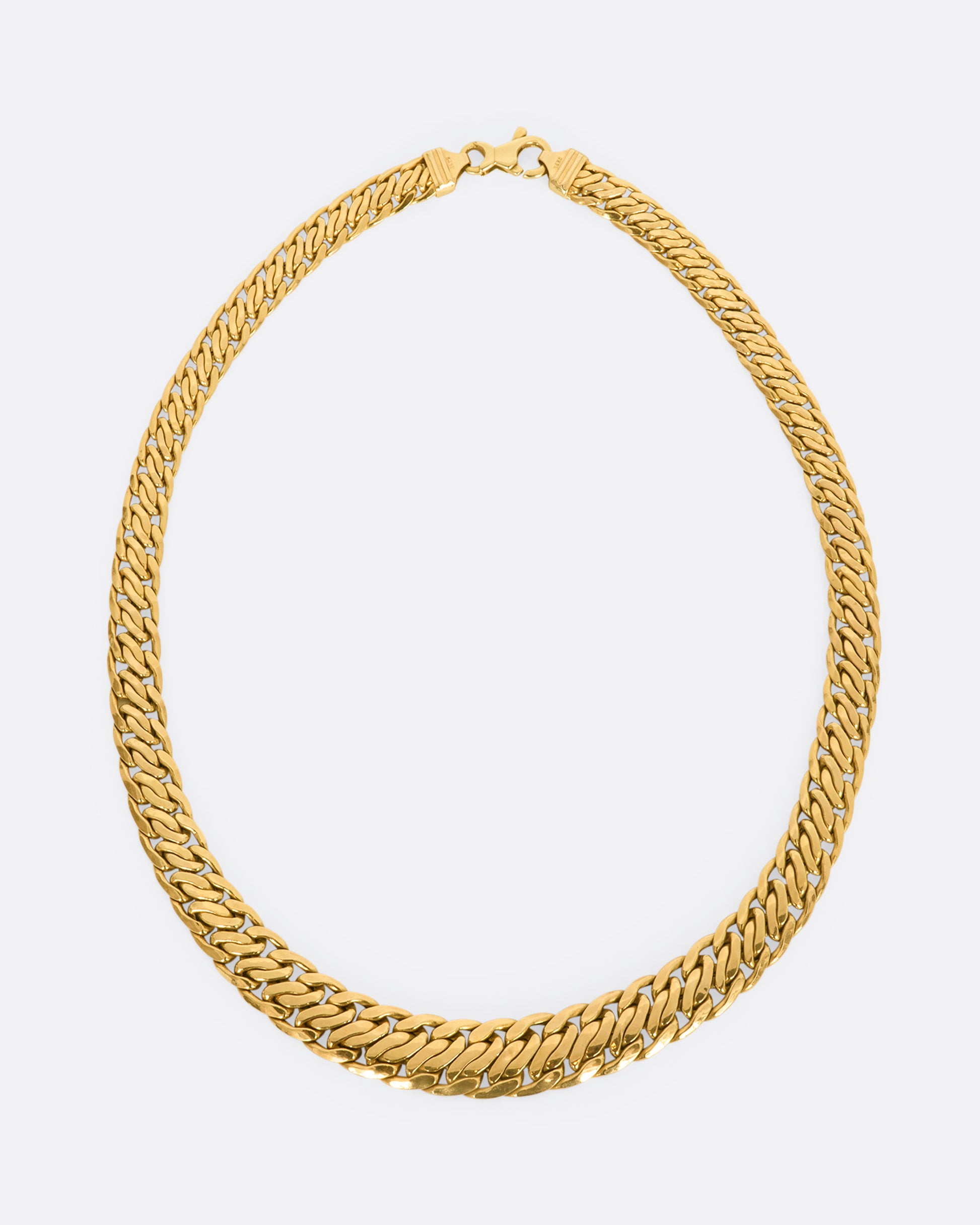 A yellow gold flat double curb chain necklace. View from above from the front.