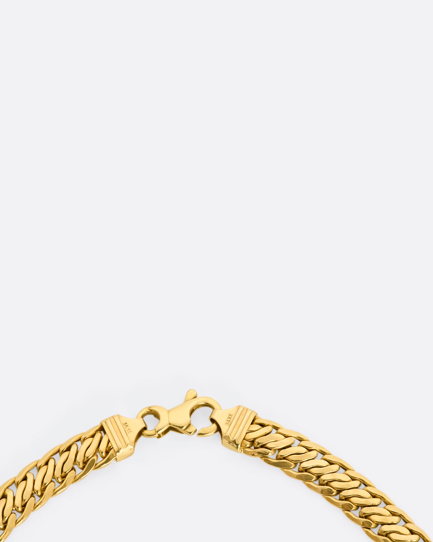 A yellow gold flat double curb chain necklace. View of the clasp.