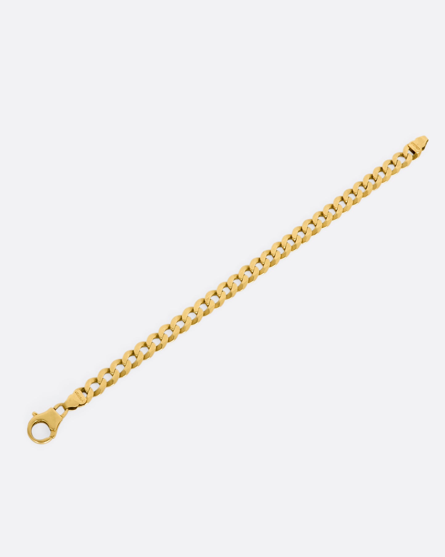 A yellow gold flat curb chain bracelet. View from above, laying flat and open.