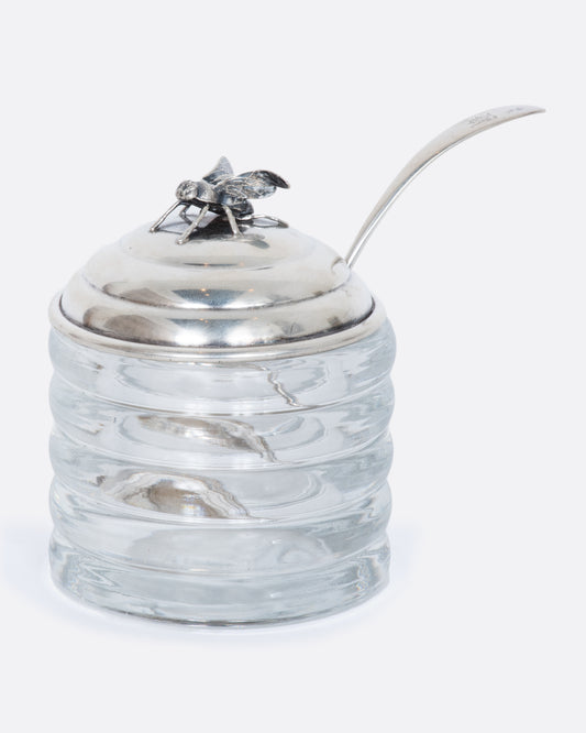 Glass honey pot with sterling lid and ladle featuring a fee on the lid. 