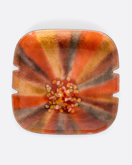 Metal enamel ashtray with sunburst pattern. View from the front.