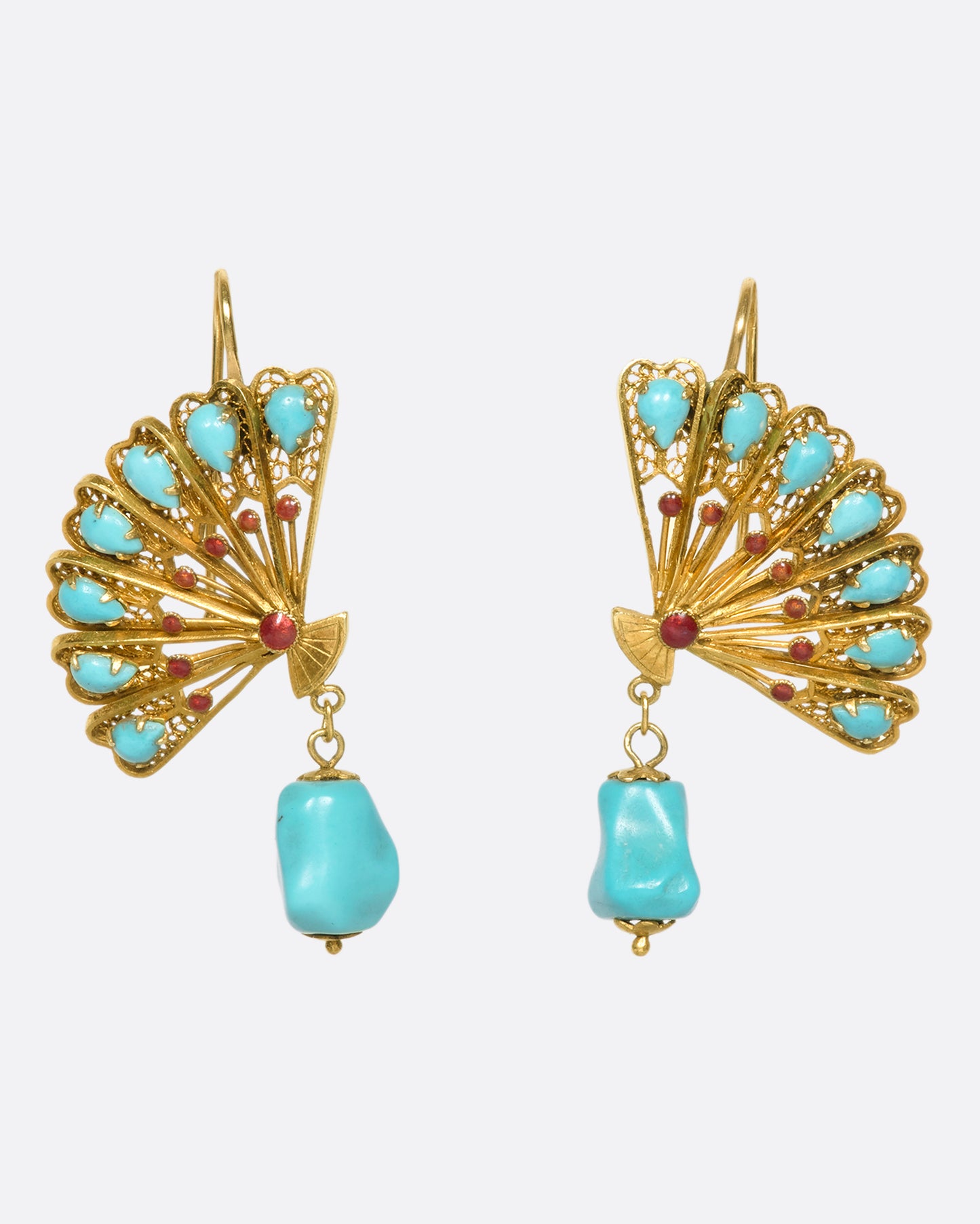 A pair of beautiful gold fan earrings with turquoises and red enamel details. We love these for their vintage vibe, versatile color palette, and sense of balance the hanging stones creates.