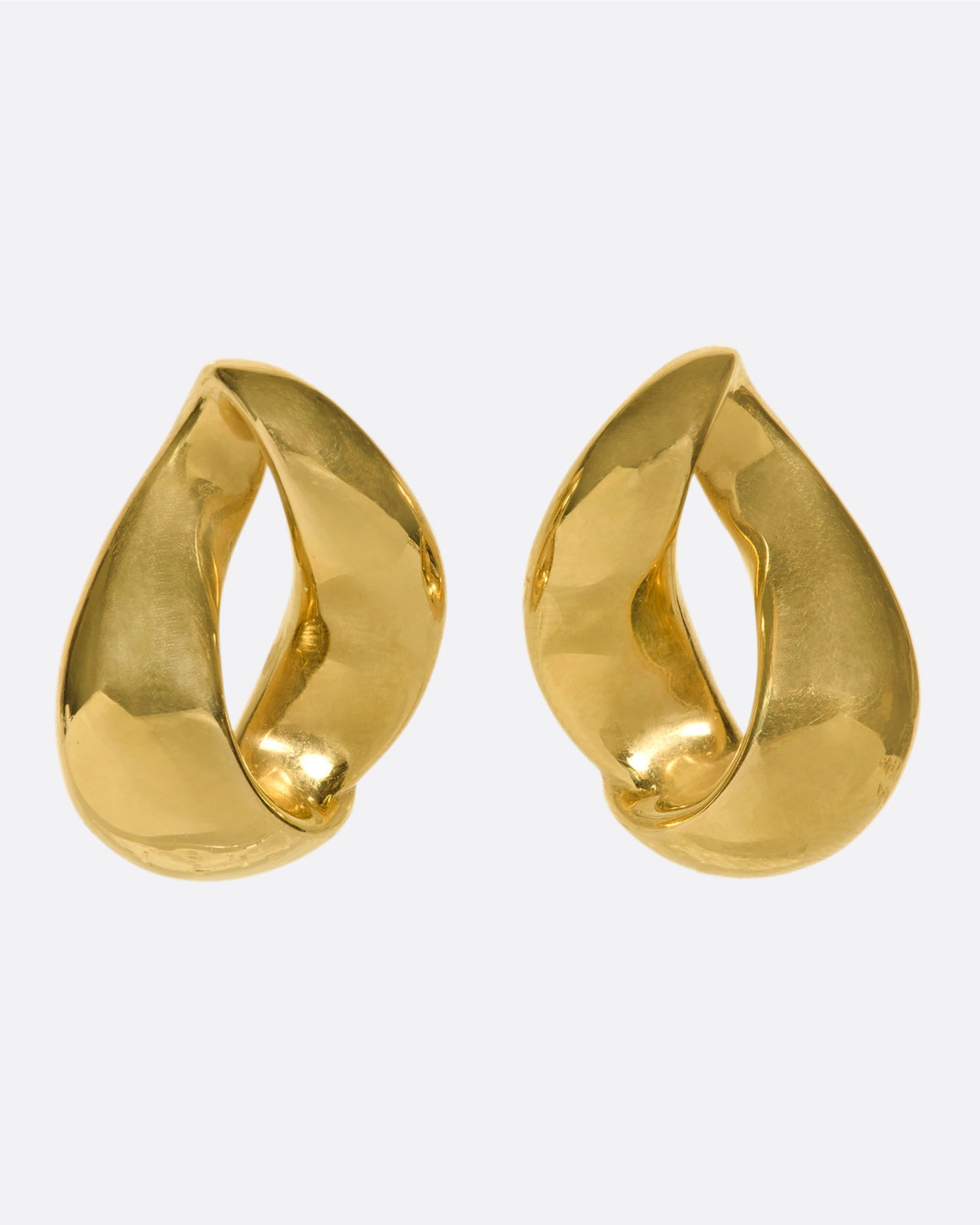 An elegant pair of 18k gold folded-hoop estate stud earrings. These are hollow and lightweight